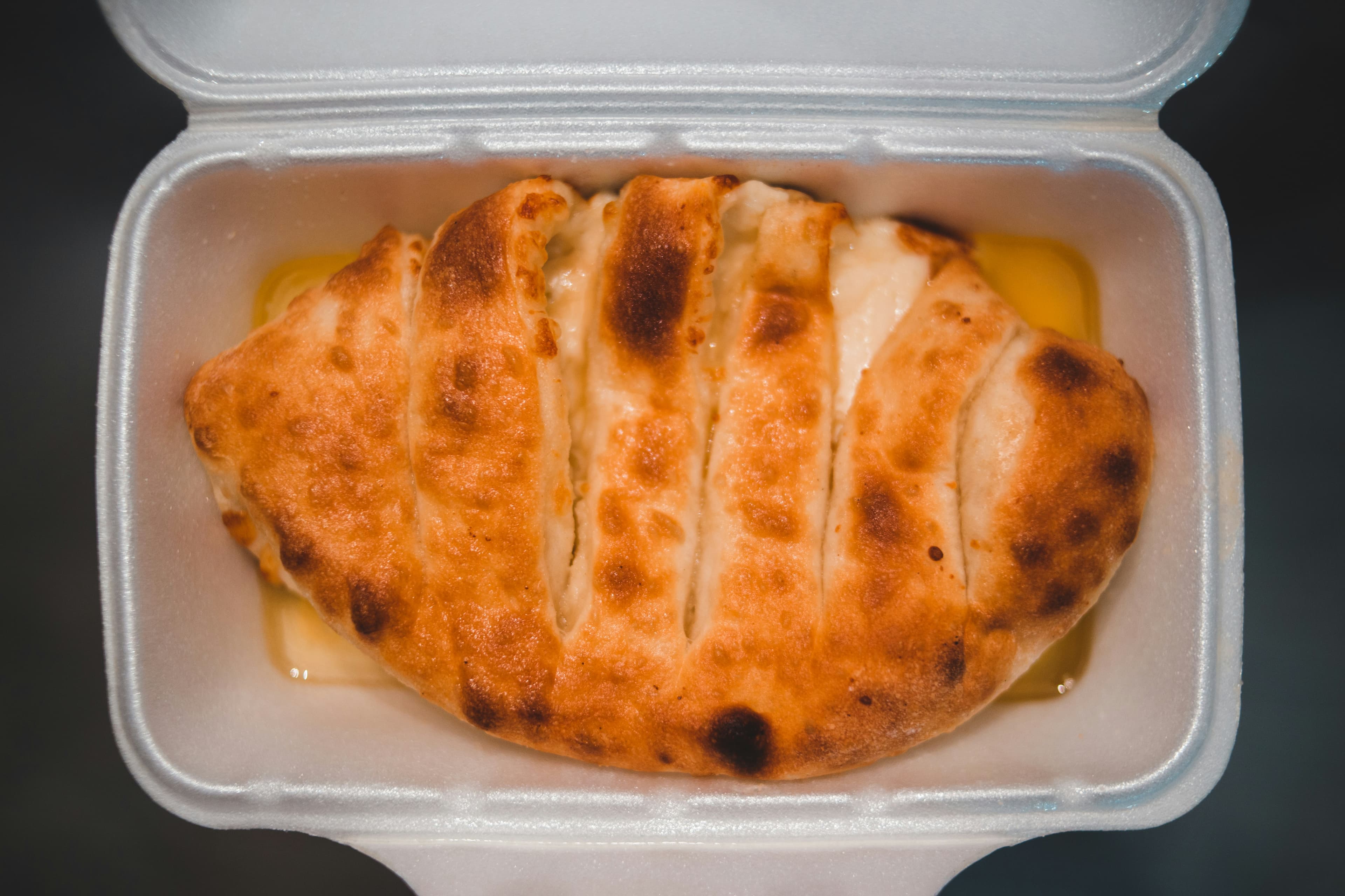 Golden baked calzone stuffed with melted cheese and mixed vegetables