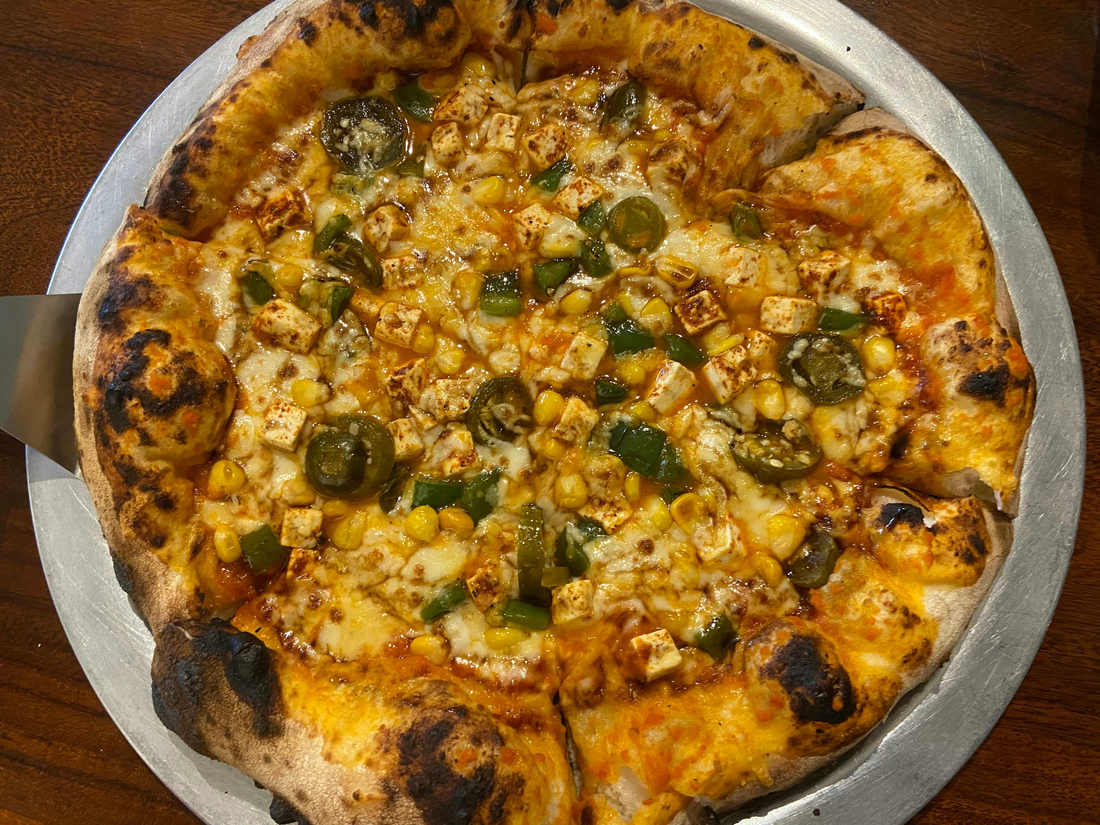 Paneer corn pizza with cottage cheese cubes and sweet corn with tandoori spices
