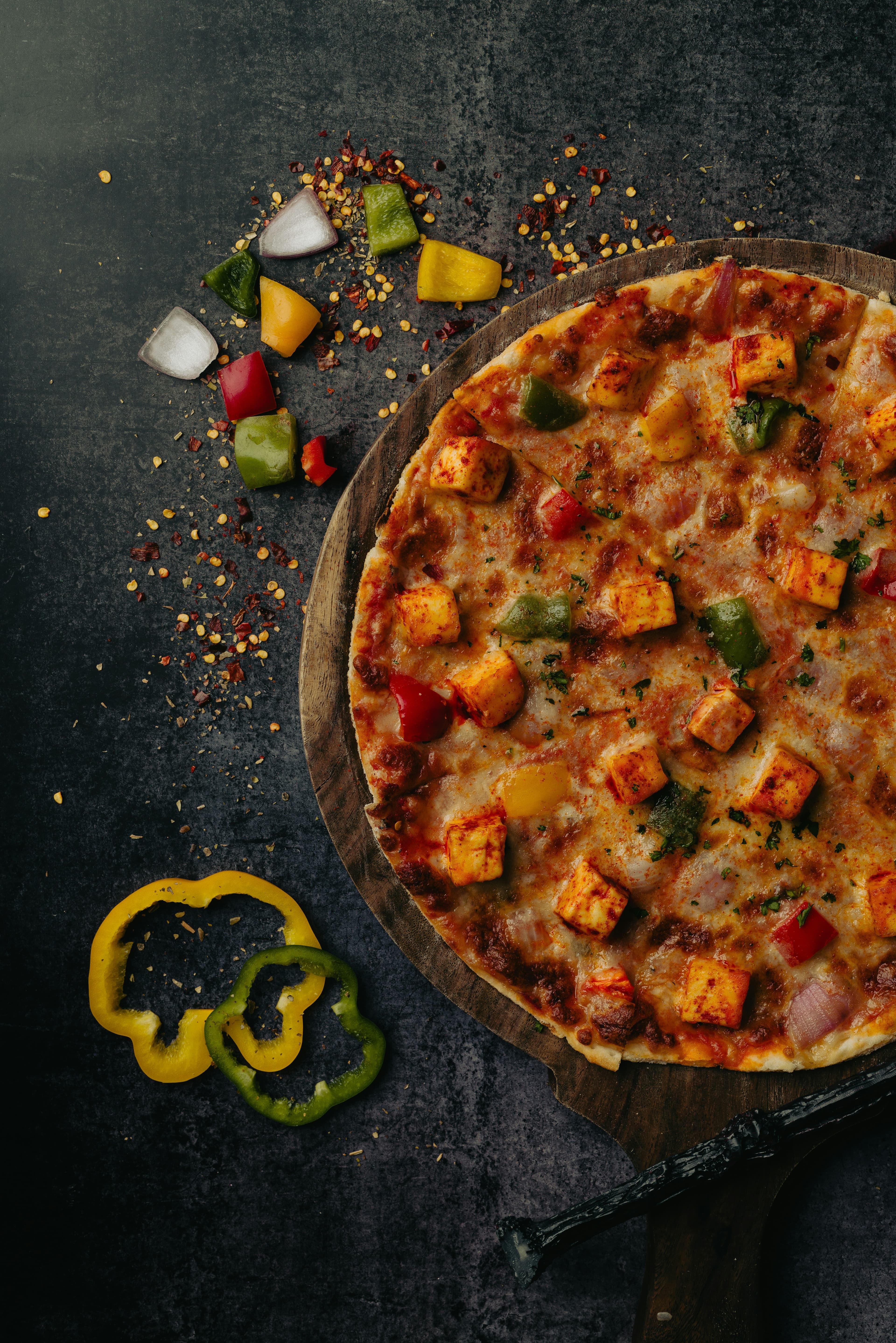 Paneer capsicum pizza with tikka paneer and colorful bell peppers