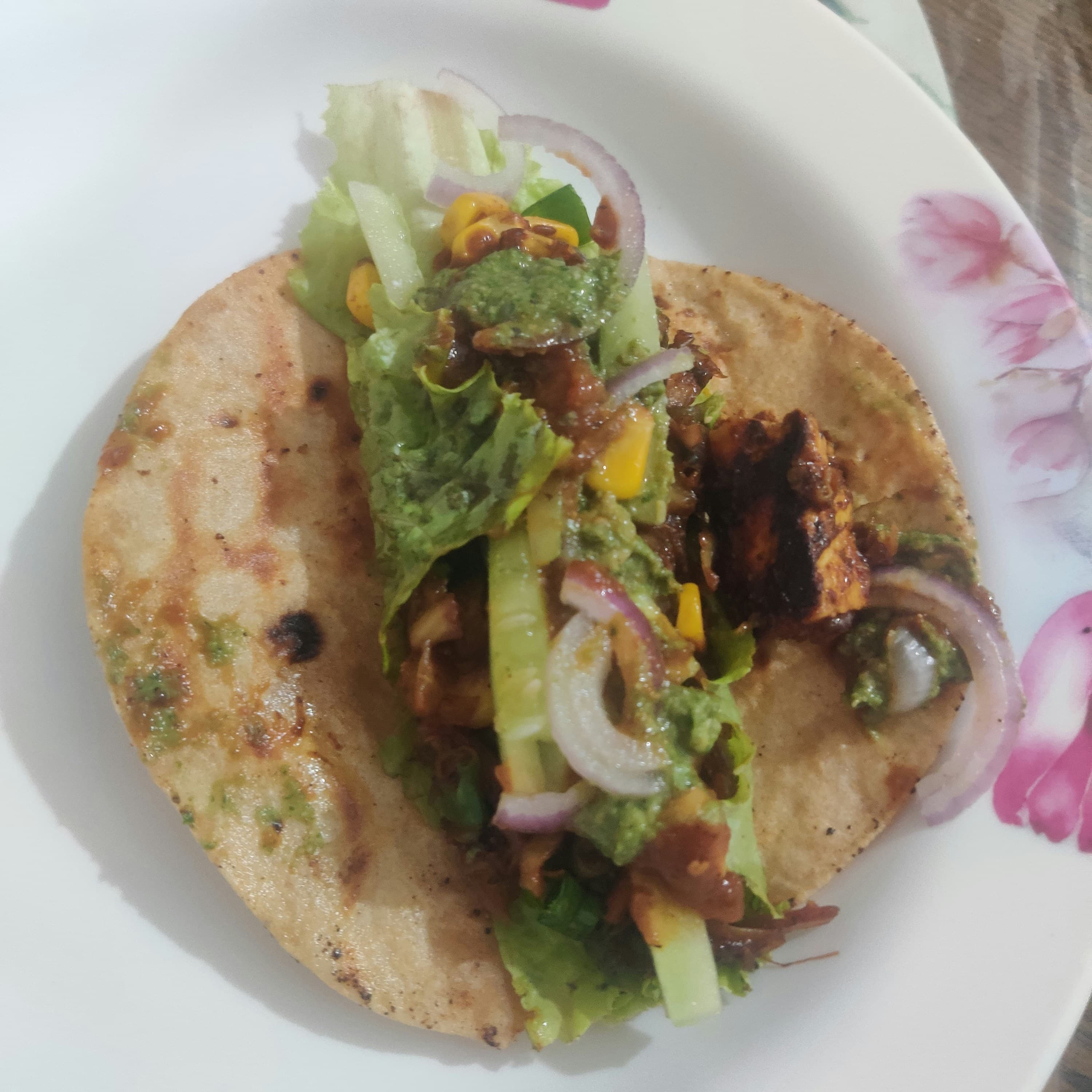 Paneer wrap with grilled cottage cheese, onions, peppers and smoky sauce in tortilla